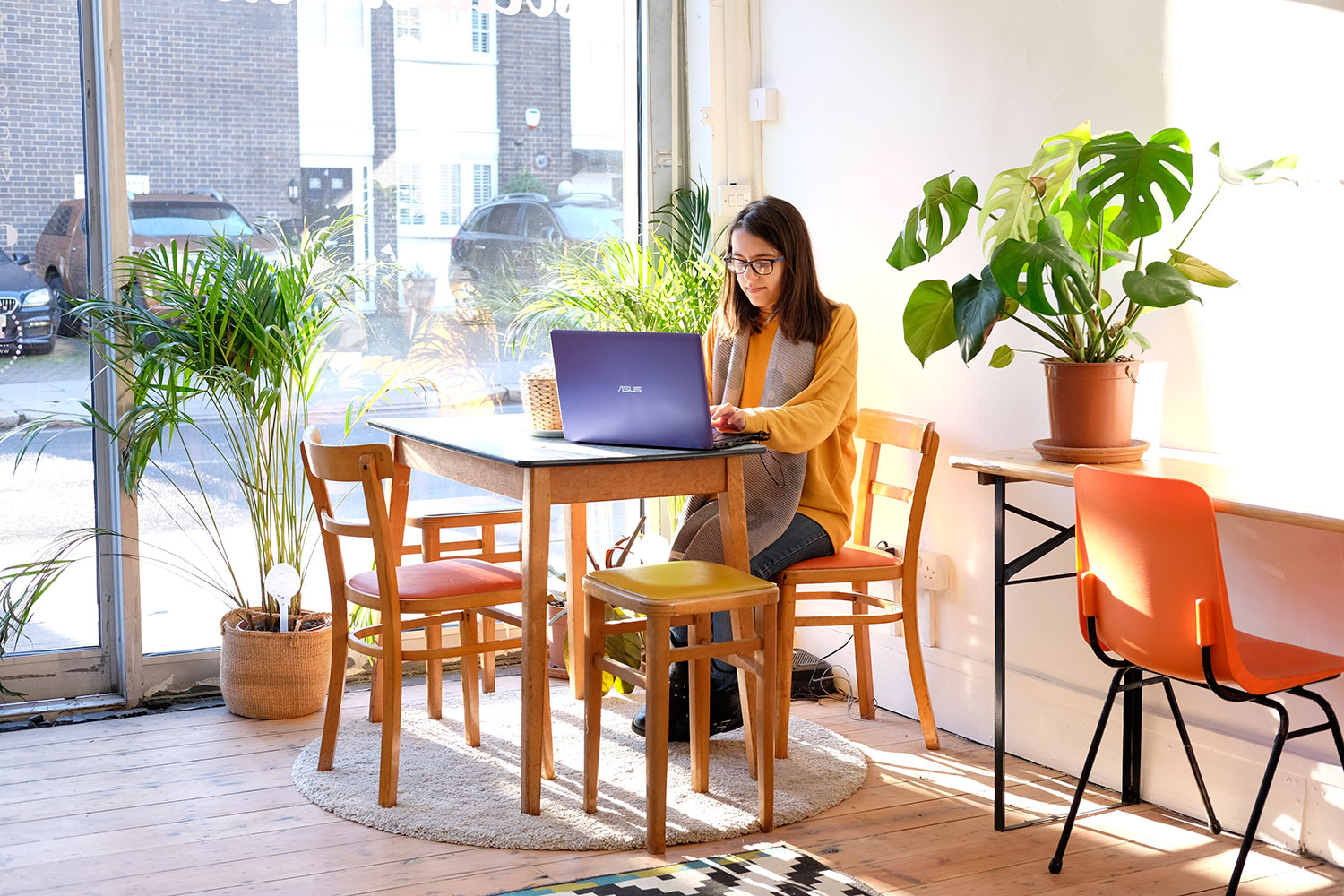 Woman hotdesking at Social Streets Co-Lab coworking space on Roman Road
